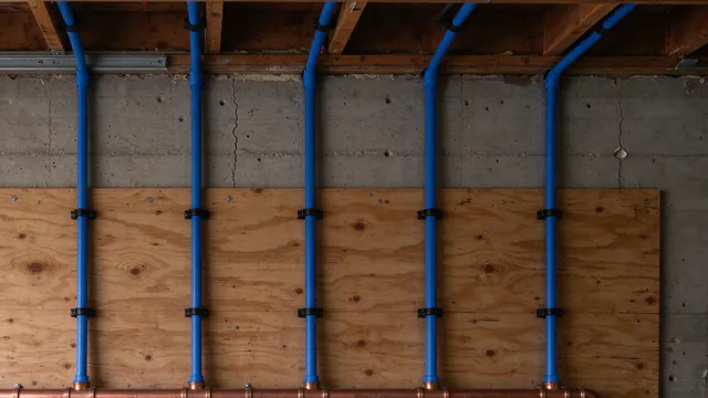 New blue PEX supply lines rising from a manifold on a garage wall