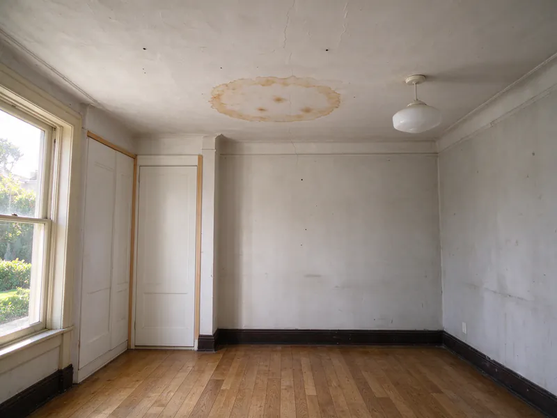 Water stain on the plaster ceiling of a room in a San Francisco flat